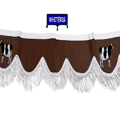 Brown leatherette tractor pelmet finished with white fringe trim and cow detailing. A stylish country-inspired upgrade for tractor cab interiors. Whiterig Truck Curtains